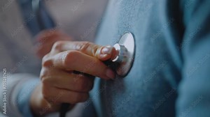 Cropped view of the woman doctor holding stethoscope and checking breath sound
