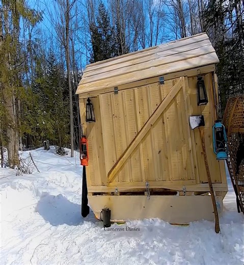 A log cabin with a small cabin sled that uses solar power and water heating to make maple syrup. | Cameron Davies