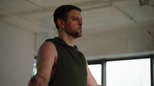 Side view of caucasian man exercising in the gym working out hard skipping rope