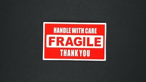 FRAGILE warning sign word text. Stop motion animation.