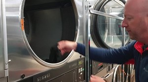 Man inserting clothes intro washing machine