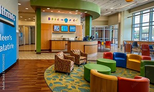 Bright, cheerful waiting area with colorful seating and a modern reception desk.