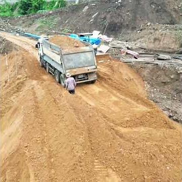 Heavy Dump Truck Dumping Red Soil To Stop The Leak
