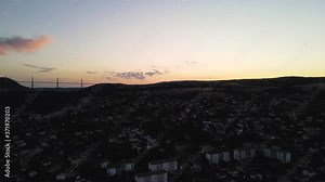 Aerial panoramic view of beautiful french city of Millau, France and famous Millau viaduct after sunset. Romantic french city nested among the hills in the evening golden hour light. Stock Video