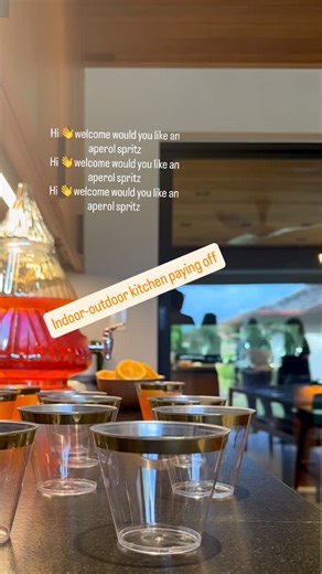 Rachel Ross Bradley on Instagram: "Our house came with a great bar space but it didn’t connect to the kitchen, except for a small pass-through window. We removed a wall and continued the kitchen right on out to the backyard and it became the space where we welcome friends and eat most of our meals. Alt. caption: Aperol for everyone 🍹 Alt. Alt. caption: it’s good to be home!"