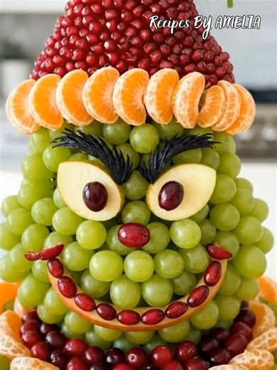 Grinchy fruit platter bringing holiday cheer! 💚🎅🍎🍊 A healthy and fun centerpiece for your Christmas party! #GrinchFruitPlatter #HealthyHoliday #ChristmasFood #EdibleArt #FruitCenterpiece | Recipes By Amelia