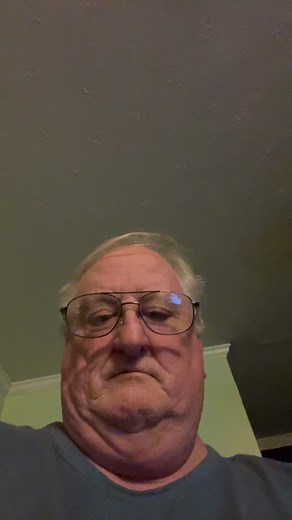 Close-Up of Individual in Blue Top on Plain Background