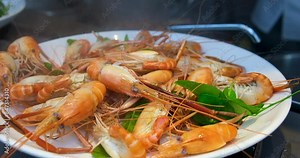 Red Shrimps Pre-Cooked and Blanched Rinsed in a Colander under Running Splashing Water in Slow Motion. Spicy Shrimp in White Plate on Set,The Famouse Menu of Thai Food in Thailand