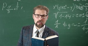 Angry bearded teacher screaming in gesticulating fiercely, unhappy with students knowledge