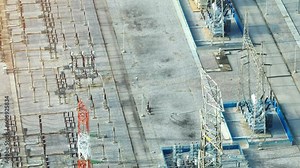 High voltage substations play a crucial role in electricity distribution, helping reduce energy loss and promote a more eco-friendly and sustainable energy grid. Bird's eye view by drone.