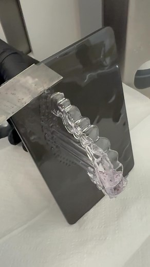 Andrea Korndörfer | Dentallabor on Instagram: "Die Schiene löst sich fast von selbst. Gedruckt, ausgehärtet, ein Schnitt mit dem Cutter, Papiertücher drunter und fertig. Aber wer denkt, damit ist’s erledigt, irrt. Das Material klebt noch an der Schiene, an den Handschuhen, an den Papiertüchern. Und das Stunden nach dem Druck. Es handelt sich um ein thermoelastisches Material. Im normalen Zustand elastisch, bei Wärme noch flexibler es ist ideal für Schienen, die sich anpassen sollen. Aber: Auch n