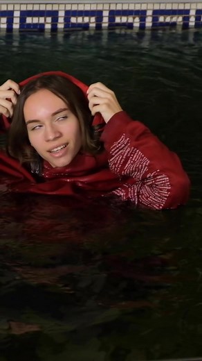 Stylish Wetlook Fashion: Fully Clothed Wet Model in Nike Jeans at the Pool