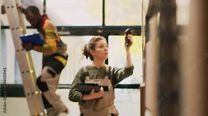 Small business manager scanning barcode using tablet and scanner during storehouse inventory, checking products stock. Supervisor reviewing cargo for distribution and logistics.