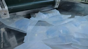 Blue Liquid Chemical Medicine Production Process By Manufacturing Worker. Blue Chemical Medicine Industrial Production At A Pharmaceutical Factory. Blue Chemical Medicine Product In Plastic Packages.