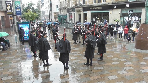 Old Scotch Pipes & Drums, Melbourne Australia, performing for the people on a very wet Buchanan St. Galleries during Piping Live on Thursday 15th August 24. | We Love Pipe Bands