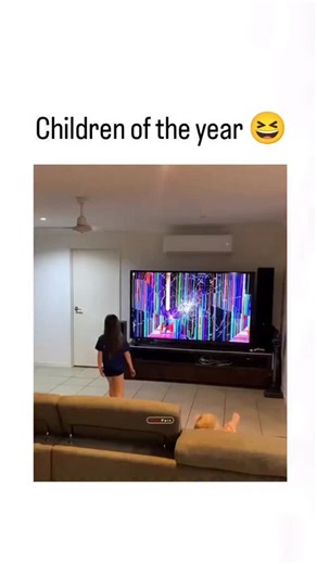 Reel Globe on Instagram: "The video depicts a mother in a living room frantically tossing her toddler onto a couch after noticing colorful glitches on their large TV screen, implying the child caused the damage, with the caption “Children of the year “ poking fun at the chaos. Posted on December 2, 2025, it exploded to 1.9 million views and 57k likes within hours drawing mixed replies: some criticize the forceful throw as risky child-handling, while others share memes appreciating the over-the-t