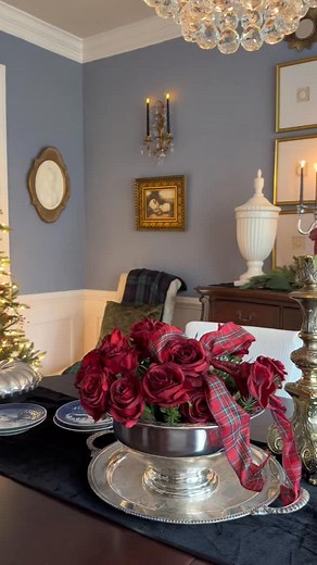 Christmas has its own language, and dark red is the word for the dining room. Roses, poinsettias, berries, and a little plaid are just enough to say Christmas is here. Im also using silverplate from my thrifted collection throughout my house this Christmas. I like how the large silver tray looks like a moon behind the silver Santa. If you don’t think it does, don’t burst my bubble. Just kidding, I’m not that fragile. 🌝 🎄🤣 #classicchristmas #traditionalchristmas #ralphlaurenchristmas | romanci