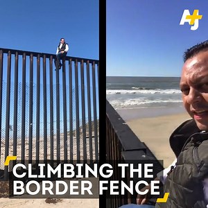A Mexican lawmaker climbed the border fence to protest against President Trump. | AJ