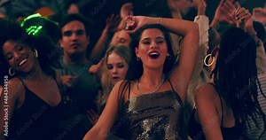 Dress like a lady, party like a rockstar. Group of beautiful young women celebrating and dancing at a party with friends. Diverse crowd having fun at a festival, concert, party, or rave