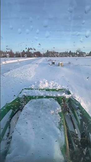 John Deere 1025r pushing 5’ snow pusher.