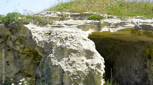View of Torre Sant'Andrea coast (St. Andrew tower) - Cliff, rocky coast with sheer, continuous cliffs. In the past centuries dwellings and shelters have been obtained by digging in the soft rock.