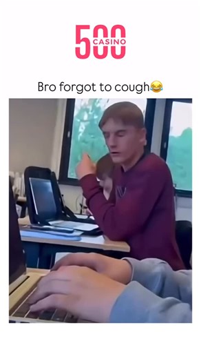 Sarcasm wrrld on Instagram: "This short video captures a moment of escalating, playful disruption in what appears to be a classroom or lecture setting. The scene focuses on two male students seated at desks with laptops. It begins by showing a close-up of a fair-haired student in a maroon sweater, sitting behind a partially opened laptop screen. He leans forward and makes an initial, small, finger-snapping gesture with his right hand, seemingly to get the attention of the person recording the vi