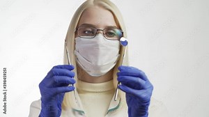Female dentist wearing mask and gloves taking mirror and starting checking teeth health of patient