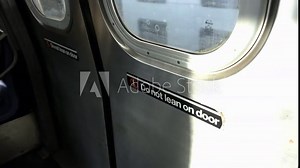 Do not lean on Door sticker in NYC Subway car. Safety on Public transit
