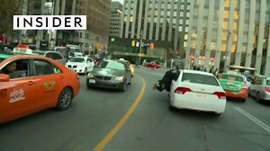 A taxi driver was so mad that he latched onto an Uber car and got dragged down the street. | Insider