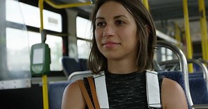Young woman riding a city bus - public transportation - close up