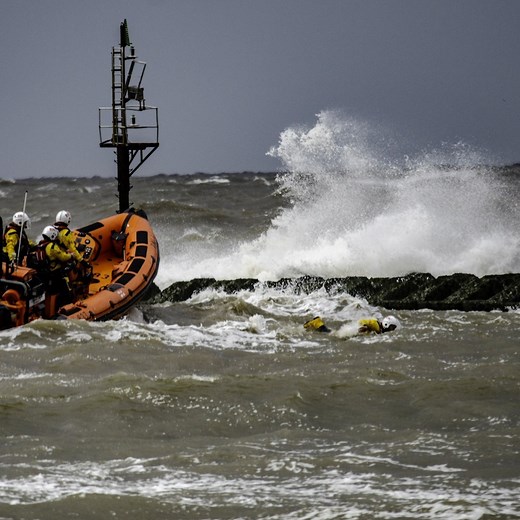 Volunteers from RNLI New Brighton Lifeboat Station launched at the request of the Coastguard after reports that two people had become stranded at the end of a groyne, cut off by the tide. With swells of up to 1.5 metres and waves crashing onto the groyne where the casualties were stranded, it was impossible to maneouvre the lifeboat next to them. This left only one option - a crew member would have to swim to the groyne to help... | RNLI