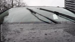 Slow motion video of window wiper blades working and cleaning window from the rain droplets Stock Video