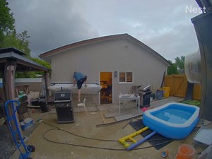 This man had a few beers when he decided to test the strength of the outdoor bar he had been building. He climbed on top of the table, and it held his weight successfully. However, while getting down onto a chair, he lost his footing and fell onto it. | Jukin Copyright Management | Facebook
