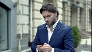 Tense and excited young man writes a text message on the go