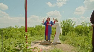 reconstruction of the pagan rite of sacrifice. the priestess and her assistant perform the ceremony, the shaman plays the tambourine. influence of paganism in the world.