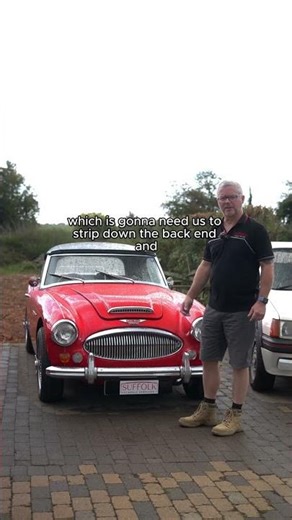 Another red Austin Healey 3000 in the workshop.
