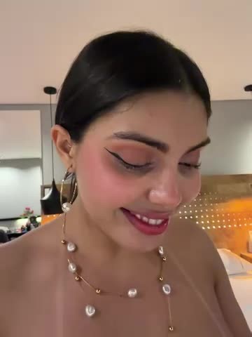 Zui_lu Stripchat HD Video | Video of a nude woman with large breasts, dark skin, and pink nails, holding her buttocks apart, in a beige-tiled bathroom. | BestCamVideos