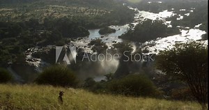 Very beautiful Epupa Falls. Series of large waterfalls created by the Cunene River on border of Angola and Namibia. Waterfall is also known as Monte Negro Falls in Angola. Wilderness landscape.