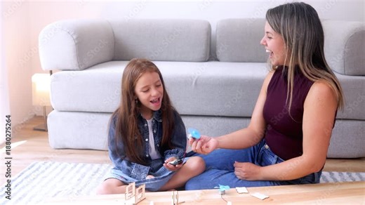 STEM education, Latina mother and daughter building green energy robotics project at home. Education and family relationship concept