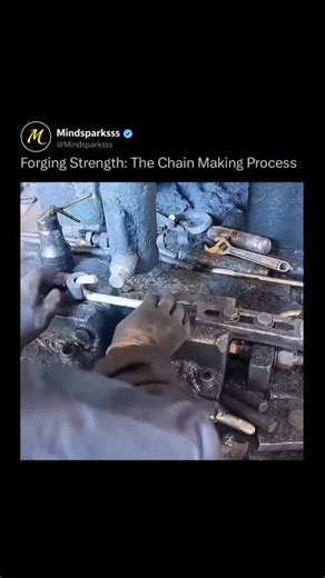 mindsparksss on Instagram: "Inside a loud, oil soaked workshop, red hot steel rods are bent, twisted, and locked into place as each new link is formed through the last, turning raw metal into something built to carry enormous weight. The process begins with straight steel wire fed into a forming machine where mechanical arms bend it into a loop around a mandrel, interlock it with the previous link, and prepare the ends for welding so the chain can grow continuously without stopping. After formin
