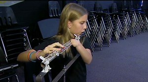 Disabled girl plays flute with one hand