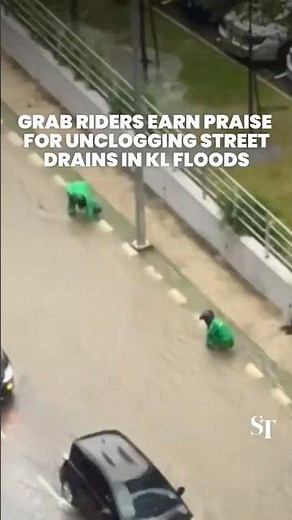 Grab riders earn praise for unclogging street drains in KL floods