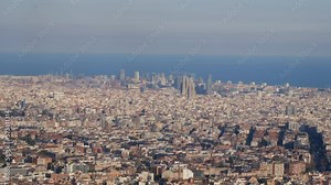 Enjoy a breathtaking panoramic view of the city of Barcelona that will leave you speechless. Observe the majesty of its iconic buildings, its blue sky, and the Mediterranean Sea, all in one image.