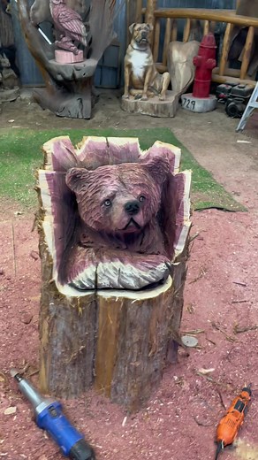 Bear Chainsaw Carving in a Log