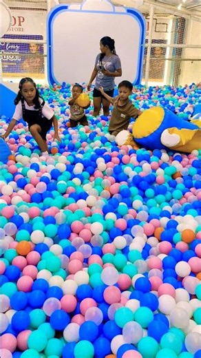 playing in a small indoor playground ball pit