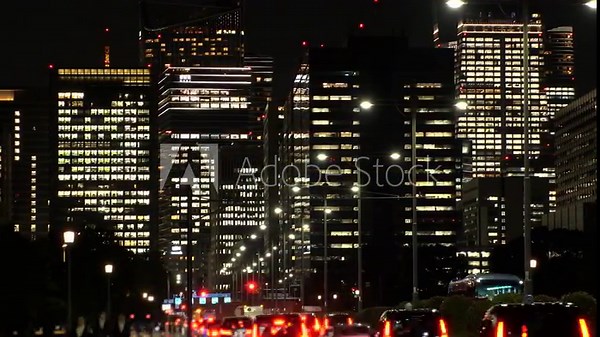 TOKYO, JAPAN - SEP 2025 : Cityscape of Tokyo at night. Vibrant business district, skyscrapers and towering office buildings. A dynamic and modern urban metropolis scene in 4K time lapse shot.