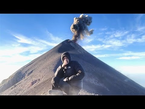Volcano Erupts Behind Meditating Man