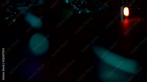 The camera moves up revealing a DJ equipment and spinning record in the background. Slow motion, dark environment.