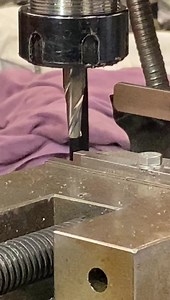 After cleaning it’s machine work, first up boring out the old tappet adjuster thread using the vertical milling machine. This changes the position of the hole to increase lift and improve consistency….. | AC Dodd