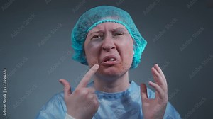 Woman, victim of an accident or abuse, with visible bruises, cuts, and a missing front tooth, wears blue hospital gown. She looks into camera, expressing pain and recounting the traumatic incident.